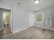 A bright bedroom features a full length mirror, closet with bi-fold doors, and an ensuite bathroom at 6892 Autumn Hills Dr, Douglasville, GA 30135
