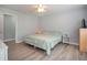 Cozy bedroom with light gray walls, hardwood floors, and plenty of natural light coming through the window at 6892 Autumn Hills Dr, Douglasville, GA 30135