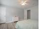 Comfortable bedroom with wood-look floors, fresh gray paint with white trim and doors, and a ceiling fan at 6892 Autumn Hills Dr, Douglasville, GA 30135