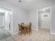 Inviting dining area with a cozy table set, tile flooring, and convenient access to other rooms at 6892 Autumn Hills Dr, Douglasville, GA 30135