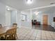 Bright dining area featuring tile flooring, with a seamless transition to an adjacent living area, perfect for gatherings at 6892 Autumn Hills Dr, Douglasville, GA 30135