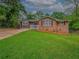 Single-story house with a brick and gray siding exterior, complemented by a lush green lawn at 6892 Autumn Hills Dr, Douglasville, GA 30135
