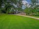 Single-story house featuring a well-manicured lawn, charming facade, and an inviting driveway at 6892 Autumn Hills Dr, Douglasville, GA 30135