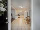 Open view from front door to kitchen and dining, with tile floors and bright white cabinets at 6892 Autumn Hills Dr, Douglasville, GA 30135