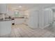 Bright kitchen with tile floors, white appliances, and subway tile backsplash, offering a clean and modern feel at 6892 Autumn Hills Dr, Douglasville, GA 30135