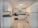 Functional kitchen featuring white appliances and cabinets, complemented by tiled floors and a contrasting backsplash at 6892 Autumn Hills Dr, Douglasville, GA 30135