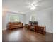 Cozy living room with hardwood floors, comfortable seating, and ample natural light, ideal for relaxing at 6892 Autumn Hills Dr, Douglasville, GA 30135