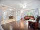 Open-concept living area with hardwood and tile flooring, connecting the seating area and dining space at 6892 Autumn Hills Dr, Douglasville, GA 30135