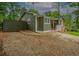 Side view of a home showing gray siding, a private fenced area, and a patio with outdoor seating at 6892 Autumn Hills Dr, Douglasville, GA 30135