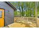 Backyard with wooden deck attached to home featuring a yellow door and gray siding at 805 Wayside Dr, Lawrenceville, GA 30046