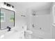 Bathroom with black hardware, bath and shower combination, and white tiling at 805 Wayside Dr, Lawrenceville, GA 30046