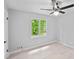 Bedroom with a window view, ceiling fan and light plank flooring at 805 Wayside Dr, Lawrenceville, GA 30046