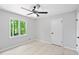 Bedroom with a window view, ceiling fan and light plank flooring at 805 Wayside Dr, Lawrenceville, GA 30046