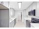 Modern kitchen with stainless steel appliances, gray cabinets, and white countertops at 805 Wayside Dr, Lawrenceville, GA 30046