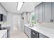 Bright kitchen with gray cabinets, stainless steel appliances and plank flooring at 805 Wayside Dr, Lawrenceville, GA 30046