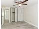 Bedroom featuring a ceiling fan, closet with sliding doors, and luxury vinyl plank flooring at 1030 Brockdell Ct, Norcross, GA 30093