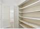 Open closet featuring multiple shelves and storage space at 1030 Brockdell Ct, Norcross, GA 30093