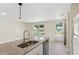 Modern kitchen features granite island with seating and stainless appliances at 1030 Brockdell Ct, Norcross, GA 30093