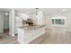 Stylish kitchen featuring white cabinets and a granite-topped island with a stainless steel sink at 1030 Brockdell Ct, Norcross, GA 30093