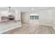 Open kitchen featuring white cabinets, stainless steel appliances, granite countertops and gray laminate floors at 1030 Brockdell Ct, Norcross, GA 30093