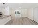 Bright living space adjacent to the kitchen with wood flooring and ample natural light at 1030 Brockdell Ct, Norcross, GA 30093