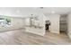 Open floor plan shows eat-in kitchen, gray laminate flooring and a window overlooking the front yard at 1030 Brockdell Ct, Norcross, GA 30093