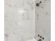 Close up of a shower with a shower head and controls, as well as white marble tiling in the shower at 1030 Brockdell Ct, Norcross, GA 30093