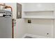 Utility room with water heater, electrical panel, white walls, and white shelves for storage at 1030 Brockdell Ct, Norcross, GA 30093