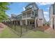 Exterior view of townhouse with a fenced-in backyard and a patio on each level at 1110 Harper Dr, Roswell, GA 30076