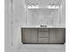Bright bathroom features gray vanity with double sinks, a large mirror, and modern lighting at 1110 Harper Dr, Roswell, GA 30076