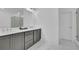 Bathroom featuring dual sinks with stone countertops and a glass-enclosed shower at 1110 Harper Dr, Roswell, GA 30076