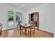 Dining area with wooden table, four chairs, and natural light streaming through the door at 1110 Harper Dr, Roswell, GA 30076