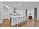 Modern kitchen with stainless steel appliances and a large center island with bar stool seating at 1110 Harper Dr, Roswell, GA 30076