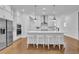 Modern kitchen features white cabinets, large island with seating, and stainless steel appliances at 1110 Harper Dr, Roswell, GA 30076