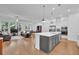 Open-concept kitchen featuring a large center island with pendant lights, and views to the living room at 1110 Harper Dr, Roswell, GA 30076