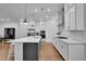 Modern kitchen features white cabinets, a large center island, and stainless steel appliances at 1110 Harper Dr, Roswell, GA 30076