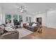 Spacious living room with hardwood floors, leather sofas and natural light at 1110 Harper Dr, Roswell, GA 30076