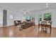 Open-concept living room featuring hardwood floors, recessed lighting, and large windows at 1110 Harper Dr, Roswell, GA 30076