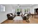 Bright living room features hardwood floors, large windows, and comfortable seating at 1110 Harper Dr, Roswell, GA 30076