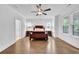 Spacious main bedroom featuring hardwood floors, multiple windows, and ample natural light at 1110 Harper Dr, Roswell, GA 30076