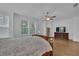 Bright main bedroom with hardwood floors, a ceiling fan, and large windows at 1110 Harper Dr, Roswell, GA 30076