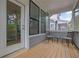 Cozy screened-in porch with wood floors, seating area and exterior view at 1110 Harper Dr, Roswell, GA 30076