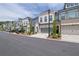 Street view of modern townhomes featuring individual garages and manicured landscaping at 1110 Harper Dr, Roswell, GA 30076