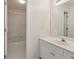 Clean bathroom featuring a vanity with a large mirror, and a shower-tub combo with white tile at 1250 Parkview Nw Ln, Kennesaw, GA 30152