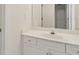 Bright bathroom featuring a white vanity with gold hardware and a large mirror at 1250 Parkview Nw Ln, Kennesaw, GA 30152