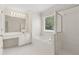 Well-lit bathroom featuring a soaking tub, a walk-in shower, and a vanity with a large mirror at 1250 Parkview Nw Ln, Kennesaw, GA 30152