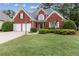 Charming red brick home with a well-manicured lawn and a two-car garage at 1250 Parkview Nw Ln, Kennesaw, GA 30152