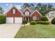 Charming red brick home with a well-manicured lawn and a two-car garage at 1250 Parkview Nw Ln, Kennesaw, GA 30152