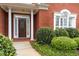 Elegant brick home with a decorative front door and manicured landscaping at 1250 Parkview Nw Ln, Kennesaw, GA 30152