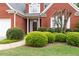 Red brick home adorned with manicured greenery and a well-maintained lawn at 1250 Parkview Nw Ln, Kennesaw, GA 30152